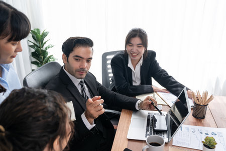 Diverse of business people from various ethnic group working in modern office environment. Productive and multi ethnic office workers engage in discussion for strategic business marketing. Meticulousの写真素材