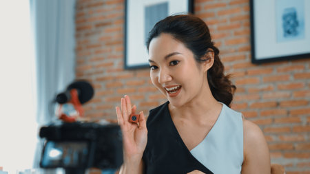 Woman influencer shoot live streaming vlog video review vivancy makeup social media or blog. Happy...