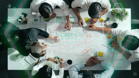 Top view of business team discussing about using clean energy and sustainable investment at meeting table with wind mill, document with environmental graph and holographic of eco power. Alimentation.の写真素材
