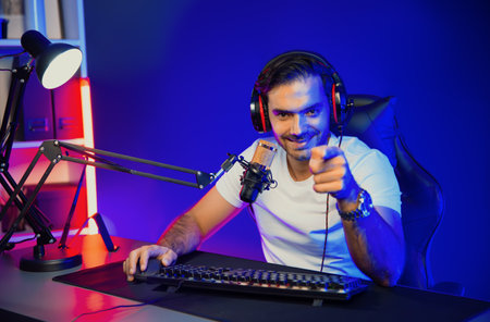 Smart gaming streamer looking at camera with trendy pose, passing the level of online game user on...