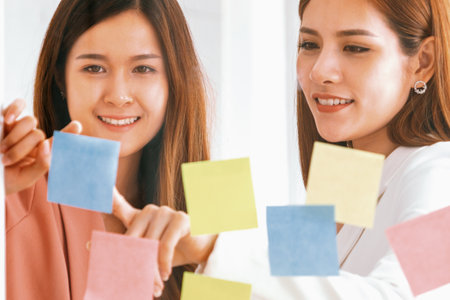 Creative Asian businesswoman in meeting workshop coming up with many positive ideas to help developing their corporate business. Group discussing and brainstorm concept. udsの写真素材
