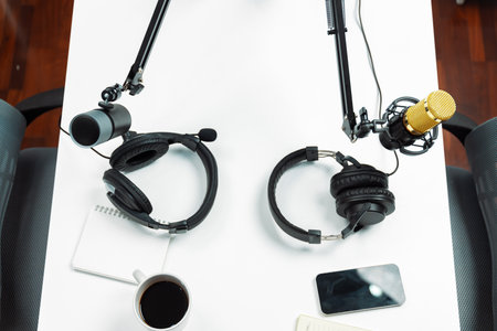 Top view modern office studio equipment microphone setting, laptop, tablet and headphone preparation...