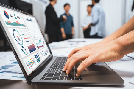 Analyst team uses BI Fintech on a laptop to analyze financial data on blurred background. Business people analyze BI dashboard for insights power into business marketing planning. Prudentの写真素材