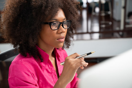 Portrait of young African woman creating website developer, thinking data information designer at home office, focusing on laptop. Concept of analytical data center in java project job. Tastemaker.の写真素材