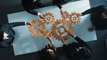 Top view of smart business people gather wooden cog together at meeting. Group of project manager helping and team working to solve problem at meeting room or workplace. Represent unity. Directorate.の写真素材