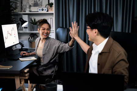 Successful Asian smart smiling business trader with partner in casual suit getting highest profit trading taking high five in exchange stock market technology investment at modern office. Infobahn.の写真素材
