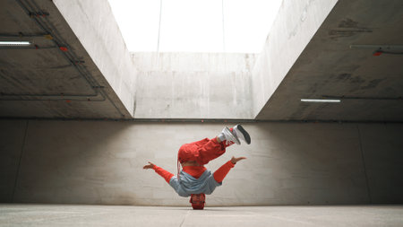 Happy dancing man enjoy practice break dance or freestyle dance in building. Professional b-boy dancer perform energetic movement or doing freeze pose modern life style. Outdoor sport 2024. Sprightly.の写真素材