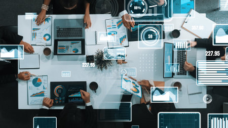 Top down aerial view of business people discussing about financial strategy on table with document and tablet display investment statistic at meeting. Diverse team brainstorm about plan. Directorate.の写真素材