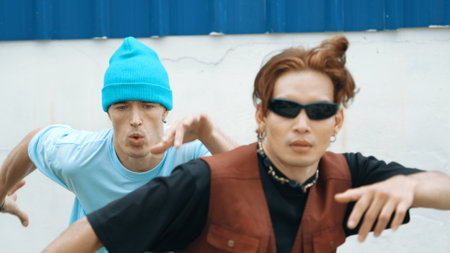 Closeup of hipster group dancing street dance together at wall. Young break dancer team practicing...