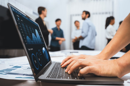 Analyst team uses BI Fintech on a laptop to analyze financial data on blurred background. Business people analyze BI dashboard for insights power into business marketing planning. Prudentの写真素材