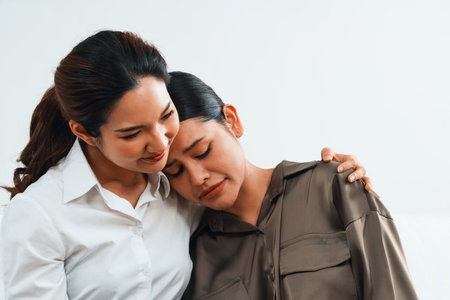 Sad PTSD woman patient in uttermost therapy for mental health with psychologist, depression or grief after life failure. Frustrated trauma young woman talking to a psychologist about emotion in clinicの写真素材