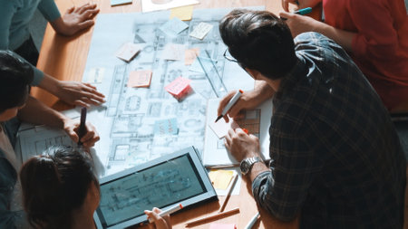 Top view of smart business team work together and holding wrist together at meeting room. Aerial view of smart architect engineer making circle by hold wrist. Represented unity, teamwork. Symposium.の写真素材