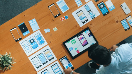 Top view of skilled developer walking and placing Ux Ui software. Smart business man put tablet on...