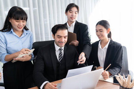 Diverse of business people from various ethnic group working in modern office environment. Productive and multi ethnic office workers engage in discussion for strategic business marketing. Meticulousの写真素材