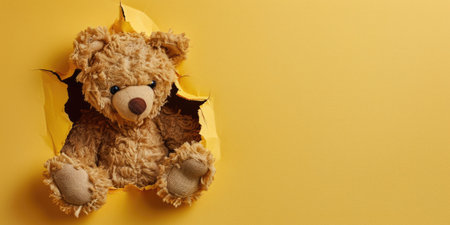 Close up view picture of the hollow yellow hole on the the wall that show the teddy stay inside the wall that has been made from some material yet still can break to look through other side. AIGX03.の素材