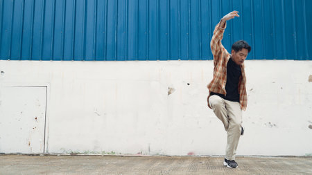 Hispanic funny choreographer dancing in hip hop style. Young happy break dancer perform b-boy dance....