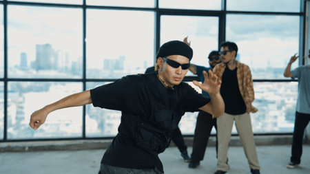 Multicultural hipster group looking at camera while perform break dancing at building with sky scrapper or city view. Street dancer team looking at dancer performance. Outdoor sport 2024. Endeavor.の写真素材
