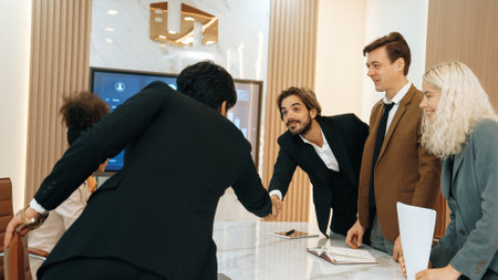 Ornament meeting room with group of diversity business people or office worker college shake hand with TV screen display companys successful marketing plan from hardworking as team.の写真素材