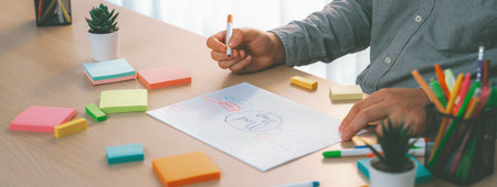 Skilled businessman brainstorms marketing ideas using mind maps. Successful male startup leader...