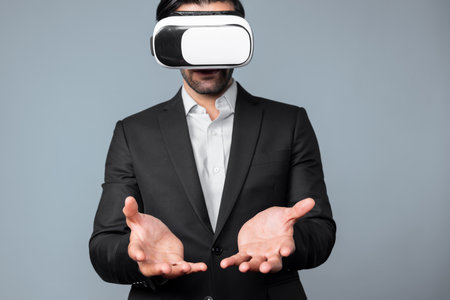 Smart business man with suit holding something while VR goggle to connect metaverse. Professional...