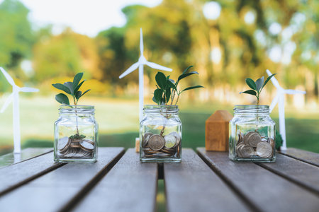 Concept of sustainable money growth investment with glass jar filled with money savings coins...