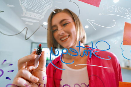 Closeup of attractive smart caucasian businesswoman brainstorms and planing marketing idea by using...