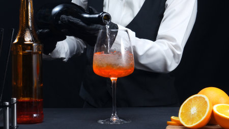 Macrography, witness the skillful hands of a bartender as they expertly mix a cocktail against a striking black background. Each close-up shot capture the fluid motion and dynamic energy. Comestible.の写真素材