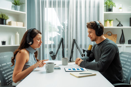 Host channel broadcaster with special guest making advice for problem in live streaming with listeners surrounded sets of live streaming on radio talking show at comfy modern workplace. Postulate.の写真素材