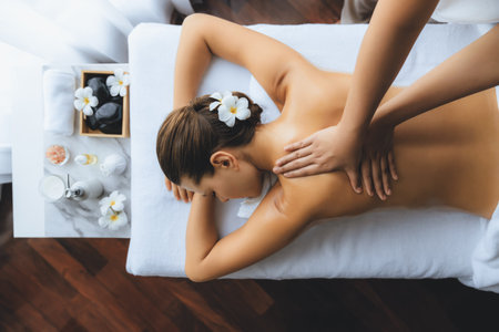 Panorama top view woman customer enjoying relaxing anti-stress spa massage and pampering with beauty skin recreation leisure in day light ambient salon spa at luxury resort or hotel. Quiescentの写真素材