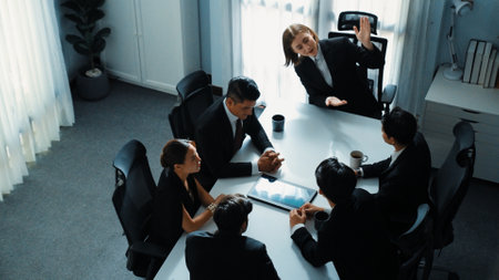 Top view of diverse business team discuss about marketing idea while businessman analyze financial graph from tablet at meeting room. Group of smart team brainstorm idea at conference. Directorate.の写真素材