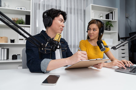 Smiling radio influencer hosts wearing headphones with channel social media online live streaming...