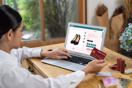Woman shopping online on internet marketplace browsing for sale items for modern lifestyle and use credit card for online payment from wallet protected by uttermost cyber security softwareの写真素材