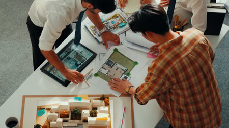 Close up of smart business team hand working together to plan design while looking at project plan...