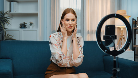 Woman influencer shoot live streaming vlog video review makeup prim social media or blog. Happy...