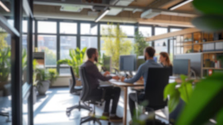 Blurred photo capturing the dynamic atmosphere of a modern open-plan office with people engaged in discussion and work. Resplendent.の写真素材
