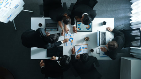 Top down aerial view of business people discussing about financial strategy on table with document and tablet display investment statistic at meeting. Diverse team brainstorm about plan. Directorate.の写真素材