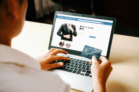 Young man use credit card for shopping payment online on laptop computer application or website. E-commerce and online shopping concept. udsの写真素材