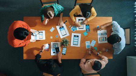 Creative team putting hand together while brainstorm about Ux Ui design mobile phone interface. People planning strategy start up project while making stack of hands at meeting room. Convocation.の写真素材