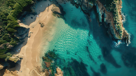 An aerial view of a coastal beach with rocks, surrounded by electric blue water. Natural landscape with oceanic and fluvial landforms, including reefs and lakes AIG50の素材