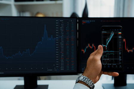 Trader businessman searching on smartphone, analyzing in dynamic stock exchange investment screen on pc with invest highest profitable financial technology market at modern home office. Surmise.の写真素材