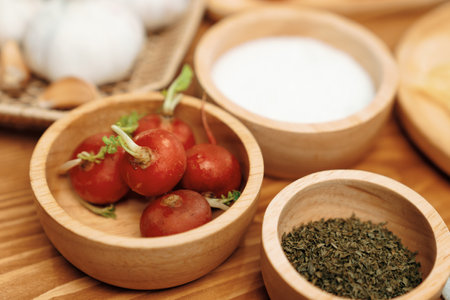 Close up in health food's Ingredients of special menu homemade cooking radish, garlic, salt, oregano, tomato and seasonings placing elements on preparing wooden table on blurred background. Postulate.の写真素材