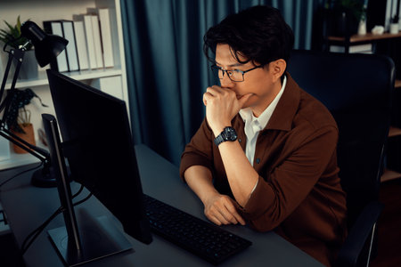 Smart businessman in casual day focusing computer to create business plan report over late night time at office, working on searching tools market planning with new startup company project. Infobahn.の写真素材