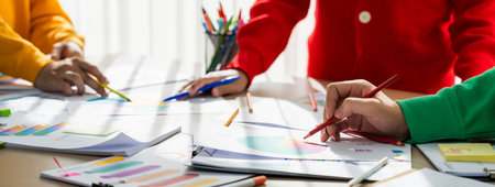 Startup company employee working together, analyzing BI dashboard paper on financial data report and...
