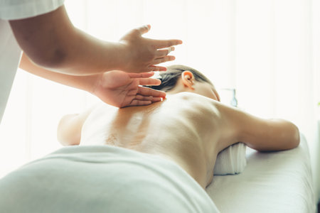 Caucasian woman customer enjoying relaxing anti-stress spa massage and pampering with beauty skin recreation leisure in day light ambient salon spa at luxury resort or hotel. Quiescentの写真素材
