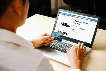 Young man use credit card for shopping payment online on laptop computer application or website. E-commerce and online shopping concept. udsの写真素材