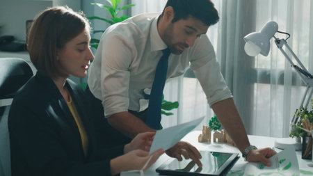 Professional business man presenting sustainable idea to manager by using tablet display ESG environmental social governance. Smart manager working together planning to use clean energy. Alimentation.の写真素材