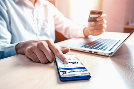 Young man use credit card for shopping payment online on laptop computer application or website....