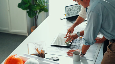 Top view of professional architect engineer team writing sticky notes and sticking note at meeting table while interior designer talking and discussing about building exterior designing. Alimentation.の写真素材