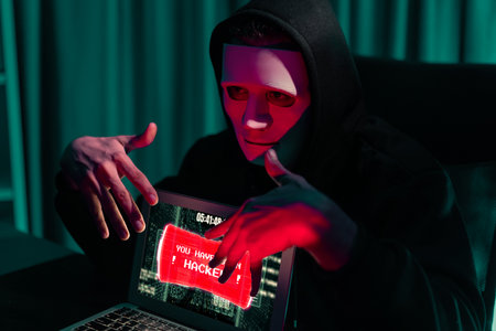 Criminal anonymous mask successful making password encryption by programming hack on laptop of insecure thorough privacy taking massive database of charge service unlock or cheat condition. Pecuniary.の写真素材