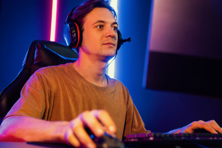 Host channel of gaming smart streamer playing online game to be winner, wearing headphone with...